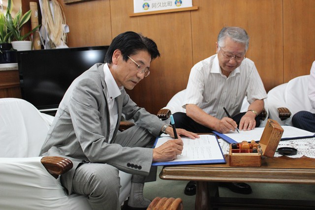 協定書に署名をする町長と株式会社中京医薬品の代表取締役社長
